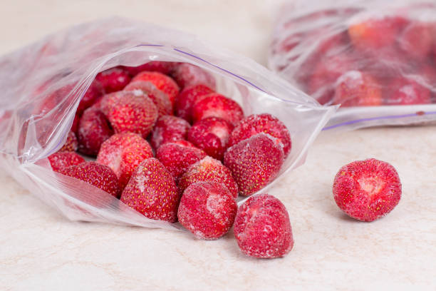 الفراولة المصرية (Egyptian Strawberries) frozen strawberries in bags, close up. stocks of meal for the winter.