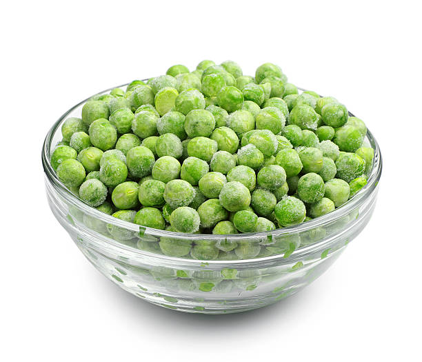 frozen peas in a glass bowl on a white background